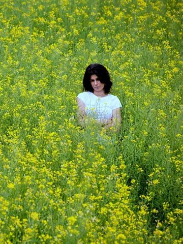 Porträt einer jungen Frau in einem Blumenfeld