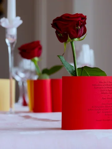 Rote Rose auf Menükarte mit Herzverzierung